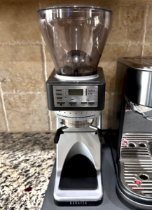 Baratza Sette 270 coffee grinder on a kitchen countertop beside a stainless steel espresso machine.