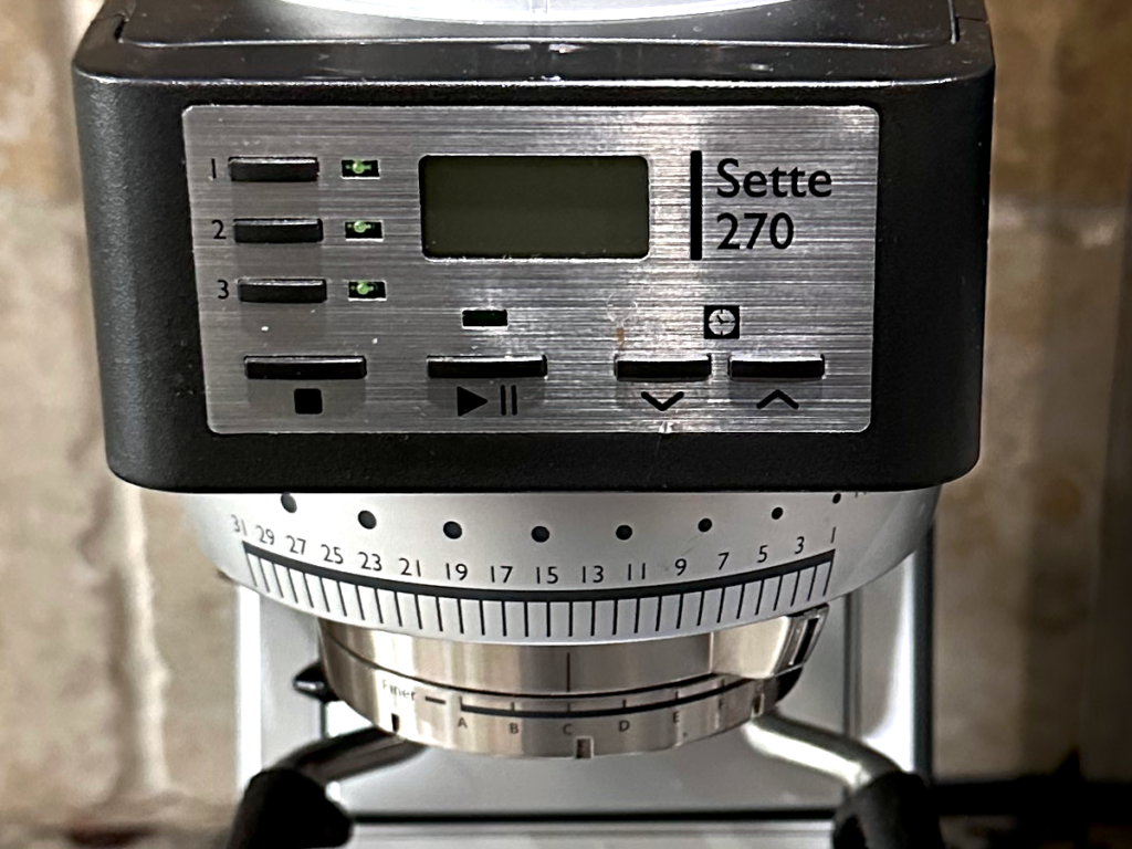 Front control panel of a Baratza Sette 270 grinder showing digital timer, programmable dose buttons, and grind size adjustment ring.