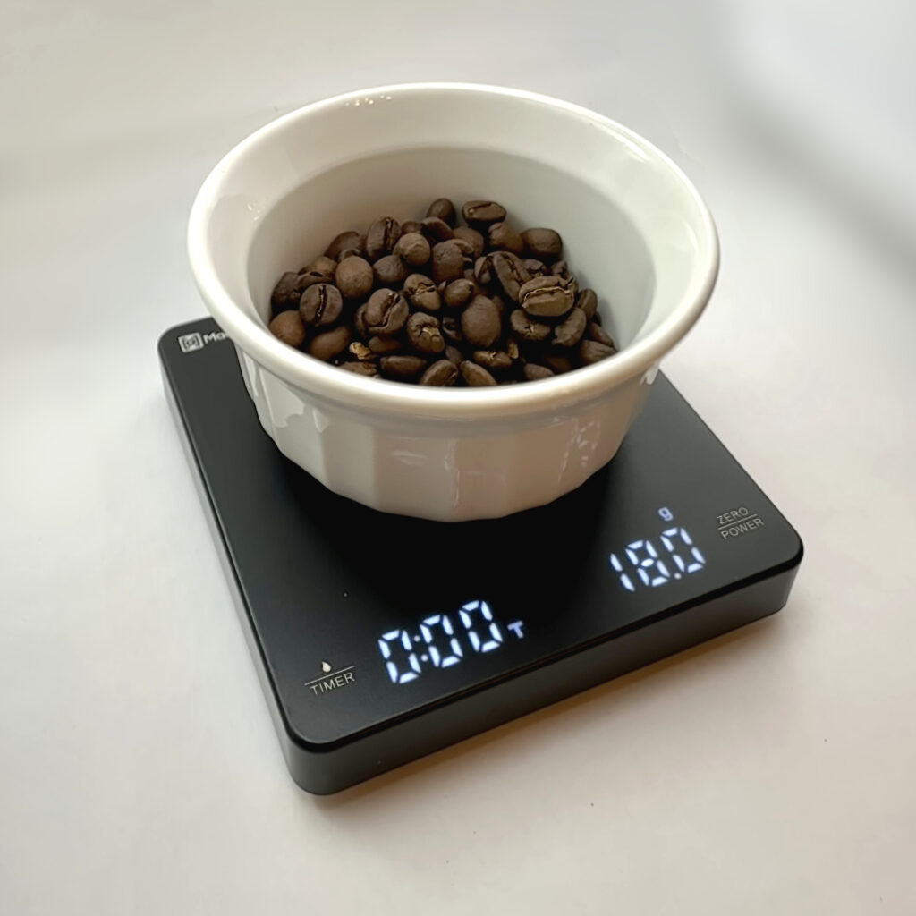 Scale with ramekin of coffee beans for bambino plus troublshooting